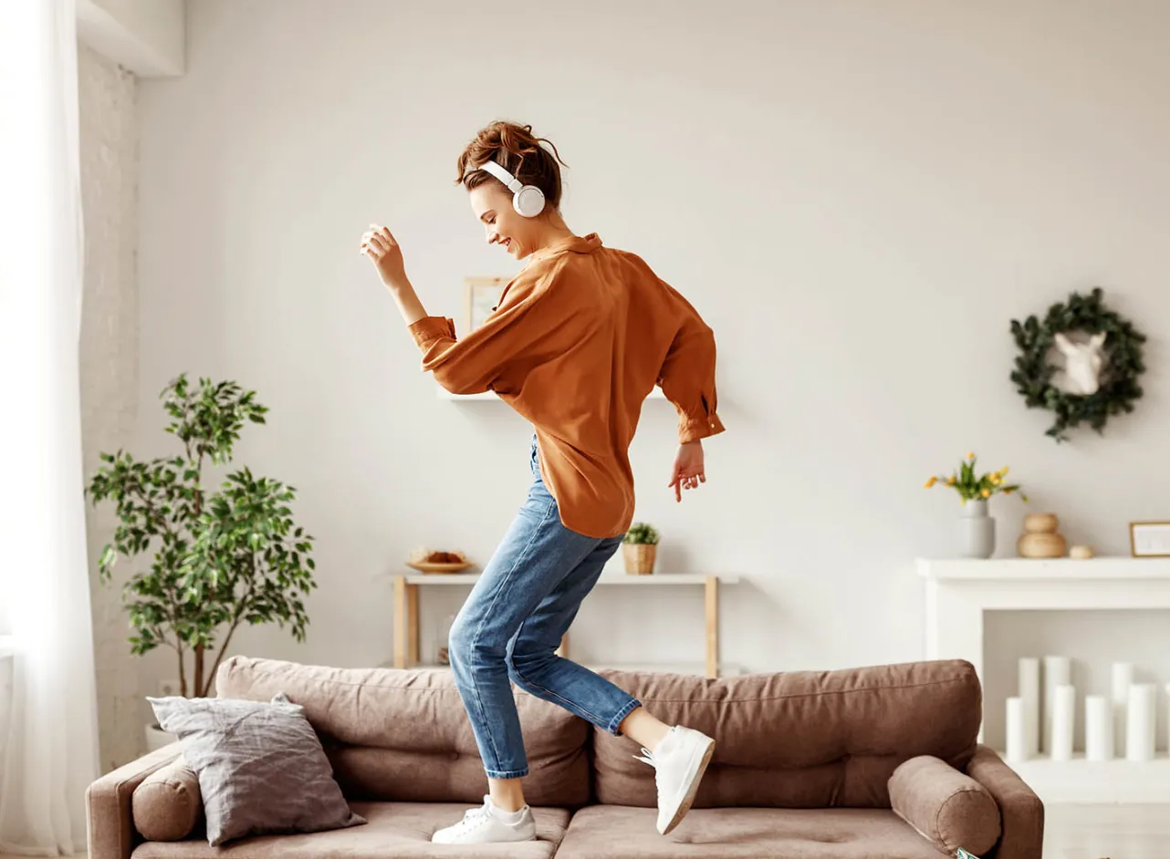 woman dancing on sofa