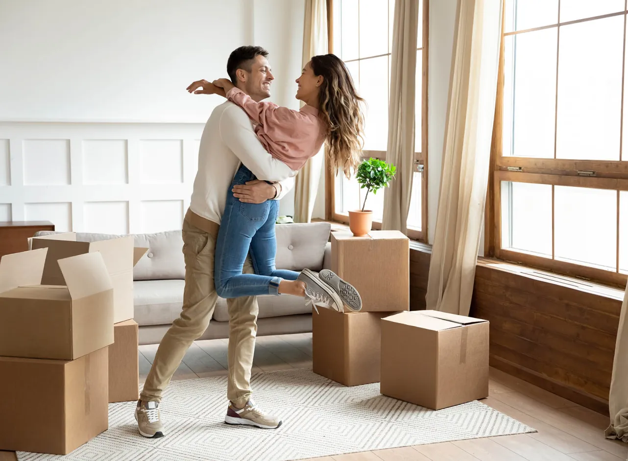 happy young couple moving into new house 