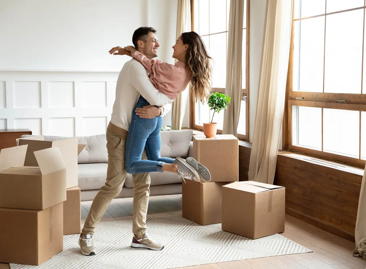 happy young couple moving into new house